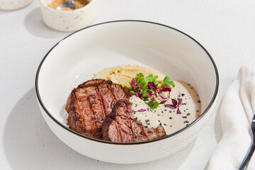 Savory Beef Medallions with Cream Sauce and Mashed Potatoes in Elegant Bowl