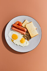 Classic Breakfast with Fried Eggs, Sausages, Mushrooms, and Toast - Stock Photo