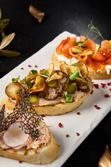 Gourmet Bruschetta Assortment with Crab, Salmon, Avocado, and Roast Beef on Elegant Dining Table