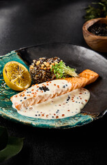 Salmon Steak with Caviar Sauce and Brown Rice Served on an Elegant Plate