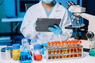 Modern medical research laboratory. female scientist hands working with micro pipettes analyzing...