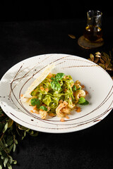 Gourmet Spinach Fettuccine Pasta with Salmon and Shrimp on Elegant Plate