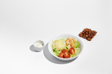 Deconstructed Caesar salad ingredients with neat geometry isolated on white background