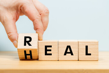 I turn over the wooden cube with the words 'Real heal'. Medical and real heal concept. Real heal...