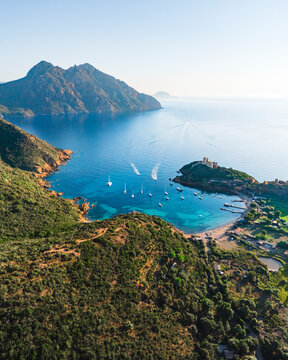 Aerial drone view of Girolata, coastal town and fort on the island of Corsica, France.