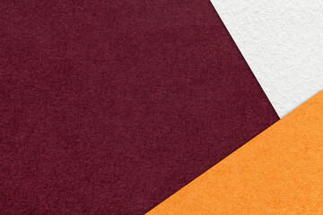 Texture of craft dark red color paper background with white and orange border. Vintage abstract wine cardboard.