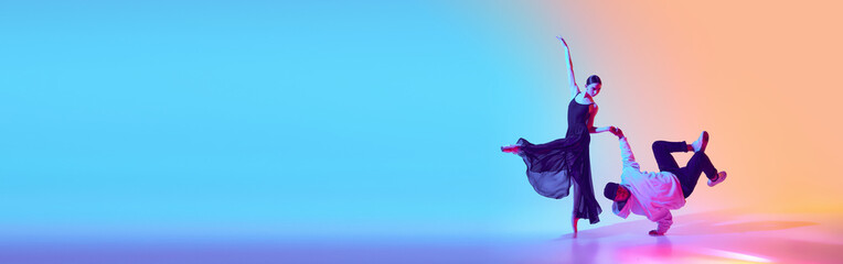Tradition meets modernity. Young girl, ballerina dancing with man, break dance, hip hop performer against gradient background in neon light. Concept of classical and modern dance, performance