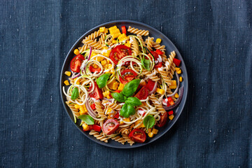 healthy pasta salad with zucchini sweet corn tomato and basil, vegetarian lunch