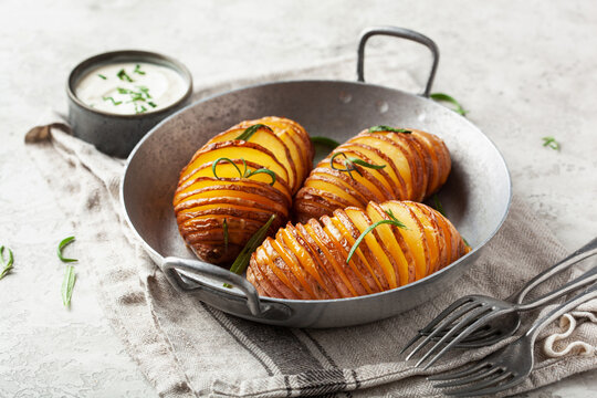 baked hasselback potato with cheddar cheese and rosemary