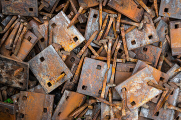 heap of rusty beasts, nails and mounting plates for old railway tracks