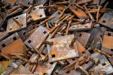 heap of rusty beasts, nails and mounting plates for old railway tracks