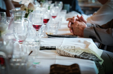 set table in a restaurant with hands in the foreground during a lunch in cheerful company