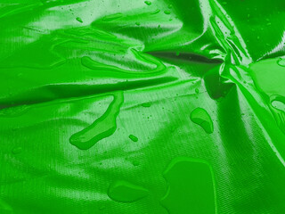 splash of water on the surface of the shiny material. drops on tarpaulin surface with beautiful...