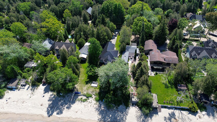 Drone shots of a beach with cottages.