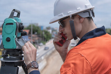 Civil engineer on construction site with survey instrument. woman work with leveling  camera on...