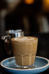 Glass of hot drink with frothy art