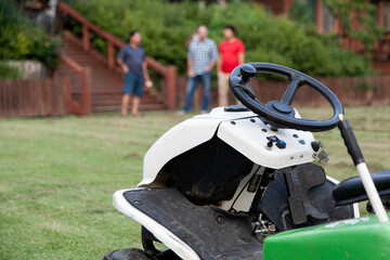View of the lawn mower on the grass field