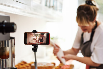 Woman, cooking or influencer with phone for social media, recipe or meal ingredients in kitchen or...