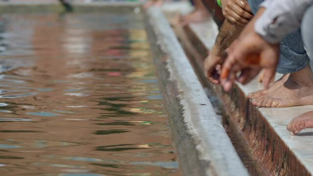 Closeup shot showing Indian Muslims washing their hands at the ablution pond during Ramadan at Jama Masjid mosque in Old Delhi, India.  