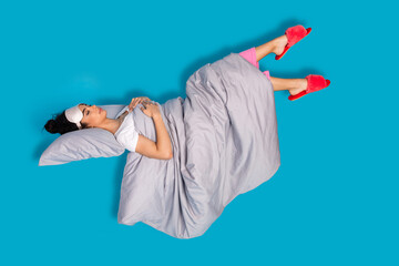 Full size photo of nice young woman sleep levitate wear pajama isolated on blue color background