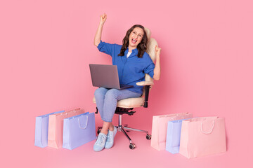 Full length photo of lovely senior lady sit armchair netbook winning shopper dressed stylish blue...