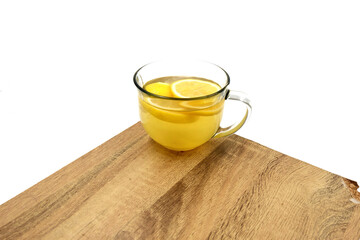 cup of water with honey and lemon slices, isolated white background, wood table