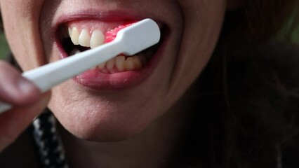 Close Up of a Caucasian Female Adult Brushing her Teeth 