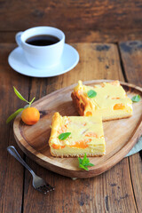 Cheese cake with mandarins a cup of coffee