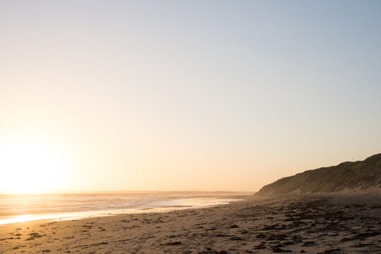 Sunset over beach with large sky