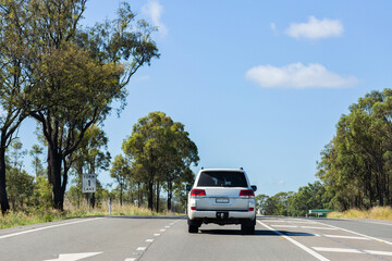 Cars on highway merging over to form one lane