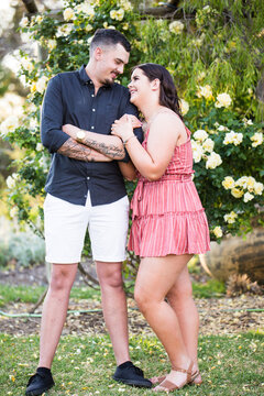 Man and woman snuggling up looking at each other smiling in love