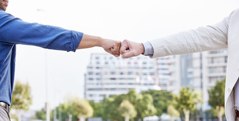 Business people, trust and hands with fist bump in city for partnership, support and help in career. Outdoor, teamwork and motivation with emoji for agreement, connection and success in b2b merger