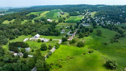 An Aerial View of Rural Homesteads and Lush Farmlands