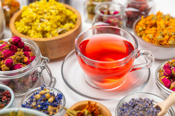 Assortment of dry herbal and berry tea and a cup of tea on a wooden background.Medicinal Healing...