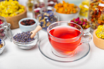 Assortment of dry herbal and berry tea and a cup of tea on a wooden background.Medicinal Healing herbs.Alternative medicine concept.Linden, calendula, cornflowers, marigold, tansy, tea rose.dry herbal