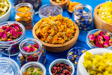 Assortment of dry herbal and berry tea on a wooden background. Tea party concept. medicinal herbs. Healing herbs.Alternative medicine.Linden, calendula, cornflowers, marigold, tansy, tea rose.