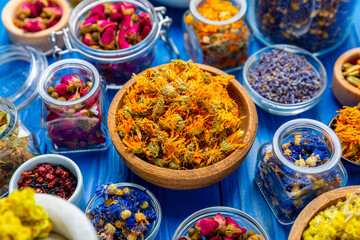 Assortment of dry herbal and berry tea on a wooden background. Tea party concept. medicinal herbs. Healing herbs.Alternative medicine.Linden, calendula, cornflowers, marigold, tansy, tea rose.