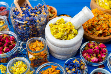Assortment of dry herbal and berry tea on a wooden background. Tea party concept. medicinal herbs. Healing herbs.Alternative medicine.Linden, calendula, cornflowers, marigold, tansy, tea rose.