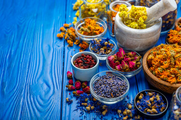 Assortment of dry herbal and berry tea on a wooden background. Tea party concept. medicinal herbs....