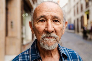 Portrait of elderly man looking into the camera - Retired people concept