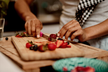 Fruit, hands and knife with person in kitchen of home for diet, health or nutrition closeup....