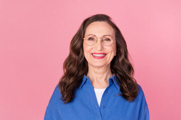 Fototapeta premium Photo portrait of attractive retired woman look camera smile dressed stylish blue clothes isolated on pink color background