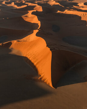 Aerial view of sandy desert landscape with sand dunes in Sossusvlei, Deadvlei, Hardap, Namibia.