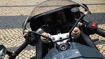 Close-up view of motorcycle handlebars and dashboard