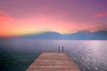 calm sunset on the wooden pier in mountains