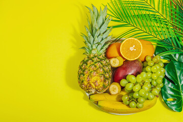 Set of fresh tropical fruits. Ripe mangoes, pineapple, oranges, grapes and bananas