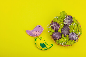 Marble Easter eggs, wooden basket, moss, gypsophila flowers. Festive concept, greeting card