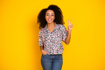 Photo portrait of pretty young girl show v-sign wear trendy leopard print outfit isolated on yellow...