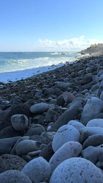 Pebble beach early in the morning. Waves on the Atlantic coast crashing against stones 