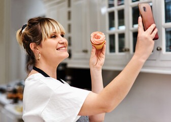 Baker, happy woman and selfie of muffin in kitchen for social media, show sweets and online blog...